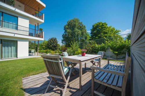 a wooden deck with a table and chairs on it at Apartment Edelweiss in Brunico