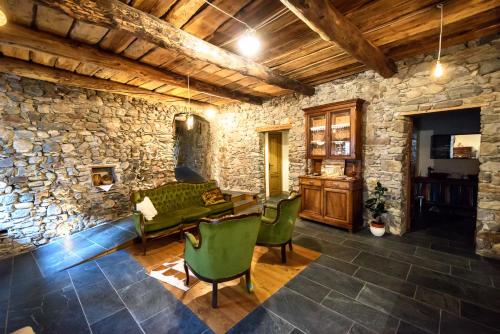 a living room with a stone wall at Ostello del Castello Tirano in Tirano