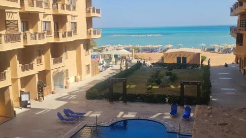 a view of a resort with a swimming pool and the beach at Comfort Zone at Turtles Beach Resort in Hurghada