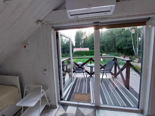 a view of a screened in porch with a sliding glass door at Apartamenti pie jūras 5 cilvēkiem, otrā stāvā in Plieņciems