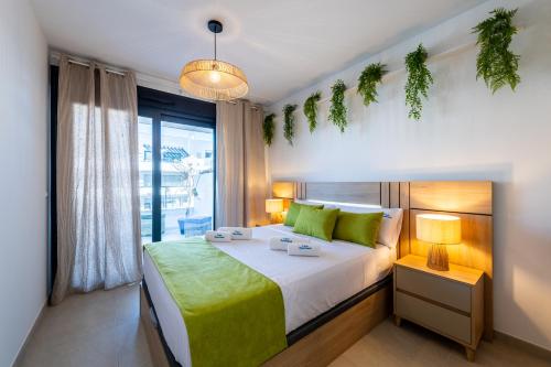 a bedroom with a large bed and a window at Apartament Flamenca Village Lime & Lemon in Orihuela Costa