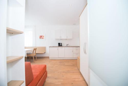 a kitchen and a living room with a refrigerator at Apartment Edelweiss in Brunico