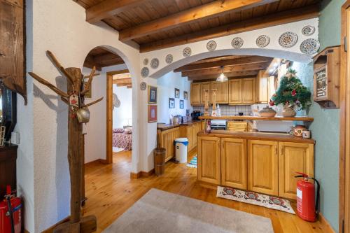 a kitchen with wooden cabinets and a christmas tree at Dandy on the hill Chalet Artemis - Fir Forest - Jeep & Nature Lovers in Eptalofos