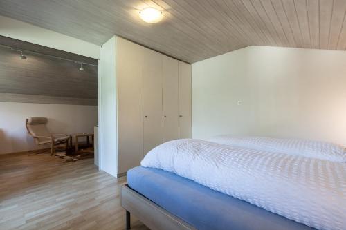 a bedroom with a bed and a desk and a chair at Chasa Gernet Buorcha in Scuol