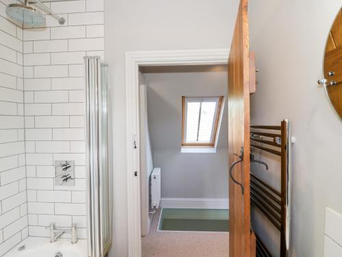 a bathroom with a shower and a sink and a tub at The Old Stables in Chipping Campden