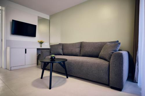 a living room with a couch and a table at Malinska Green Apartments in Malinska