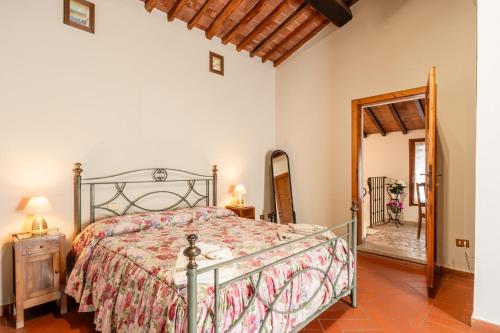 a bedroom with a bed and a mirror at La Bella Toscana Ulivo Apartment in Monsummano Terme