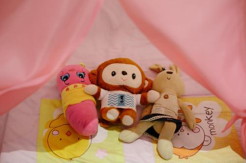 a group of stuffed animals sitting on a bed at Kangsar Inn 73 in George Town