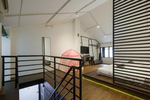 a room with two bunk beds and a desk at Kangsar Inn 73 in George Town