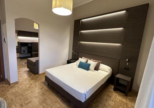 a bedroom with a large bed with a black headboard at Hotel Continentale in Arezzo