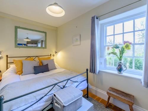 a bedroom with a bed and a window at 2 bed in Appledore 80567 in Appledore