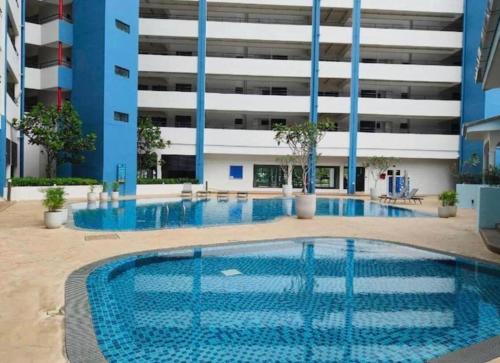 a large swimming pool in front of a building at Mutiara Melaka Beach Resort by TZWan in Tangga Batu