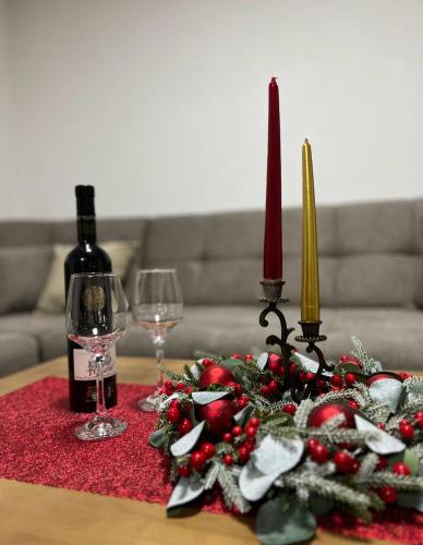 a table with a bottle of wine and two candles at Villa Dejana Vlašić in Šišava