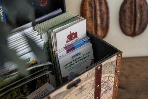 a box full of books sitting on a table at Rozeboom Loft in Aartrijke