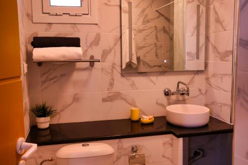 a bathroom with a sink and a toilet at Villa Yolanda 3 - Apartment Leda - Luxury family apartment, sea view in Poros