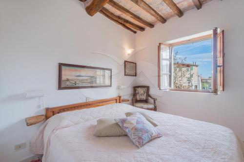 a bedroom with a large bed and a window at Appartamento La Scaletta in Capoliveri