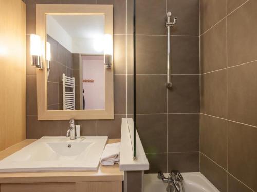 a bathroom with a sink and a shower at Residence & Spa Les Chalets de Solaise in Val dʼIsère