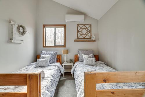 a bedroom with two beds and a window at Peaceful Pocono Pines Getaway Hot Tub and Fire Pit! in Pocono Pines
