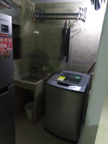 a small kitchen with a sink and a refrigerator at Apartamento vía a Minca in Santa Marta