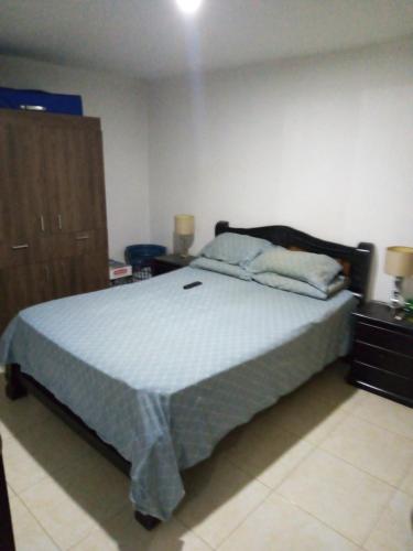 a bedroom with a large bed in a room at Apartamento vía a Minca in Santa Marta