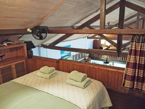 a bedroom with a bed with two towels on it at Casa dos Botes in Santa Cruz das Flores