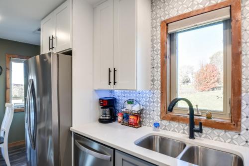 a kitchen with a sink and a refrigerator at Cozy Illinois Abode with Deck and Grill, Near Golfing! in Galena