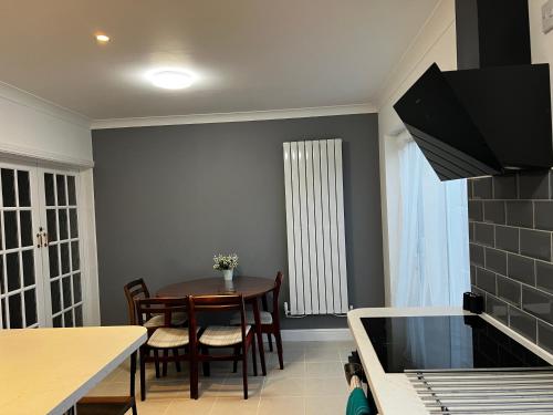 a kitchen with a table and a dining room at Springfield House- Near Newcastle Centre, Hospital and Keele University! in Stoke on Trent