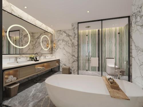 a bathroom with a tub and a sink and a toilet at Argyle Grand Hotel Nairobi Airport in Nairobi