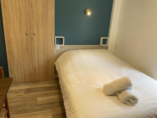 a small bedroom with a bed with a towel on it at Studio Aix-les-Bains, 1 pièce, 2 personnes - FR-1-617-23 in Aix-les-Bains