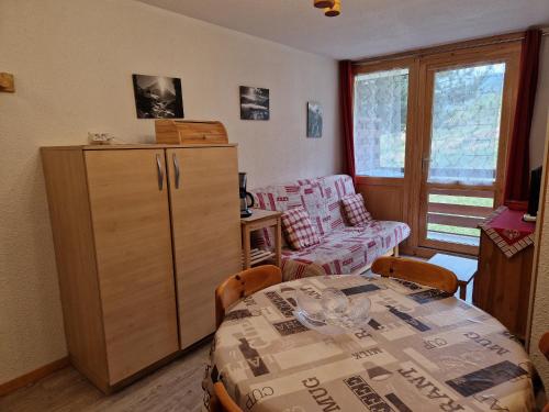 a room with a table and chairs and a room with a table and a table at Appartement La Plagne Montalbert , 2 pièces, 4 personnes - FR-1-755-4 in Aime-La Plagne
