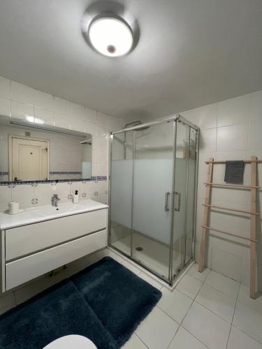 un bagno con doccia in vetro e lavandino di GROW- Casa Parque da Cidade a Porto