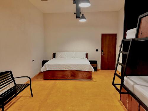 a bedroom with a bed and a ladder in it at Caleta Hostel Rooftop & Pool in Cancún