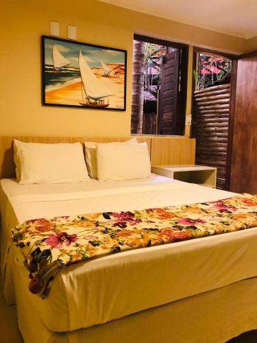 Una cama o camas en una habitación de Hotel Pousada Latitude