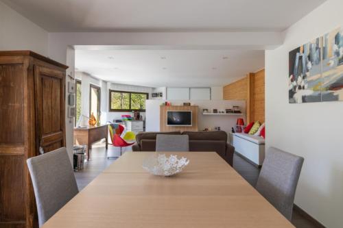 Il dispose d'une cuisine et d'un salon avec une table et des chaises en bois. dans l'établissement La Tour 74, à Thônes