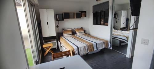 une petite pièce avec un lit et une table dans l'établissement Studio Les Corsaires, à Berck-sur-Mer