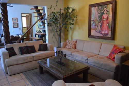 a living room with a couch and a coffee table at en corazón centro Histórico, in Morelia