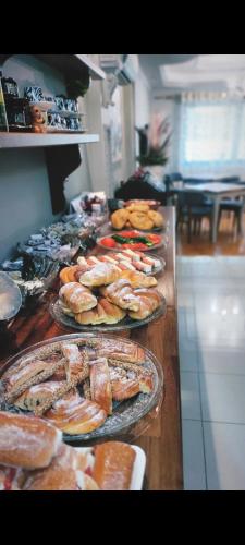 a buffet with several plates of food on a table at Vila Mariss in Korçë