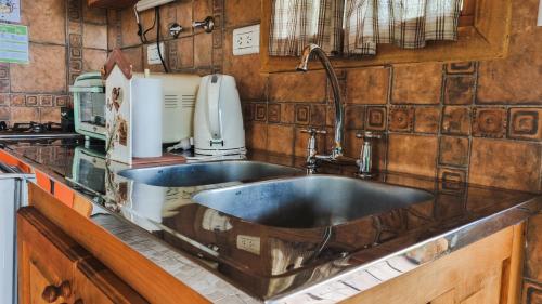 a kitchen counter with two sinks in a kitchen at CABAÑAS LOS ARÁNDANOS in Tolhuin