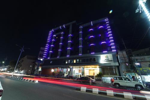 a building with purple lights on it at night at Dvr Mansion in Kurnool