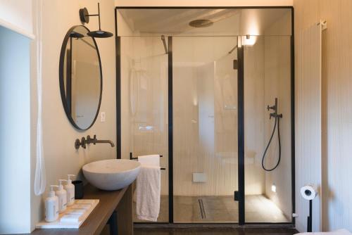 a bathroom with a glass shower with a sink at Dimora Cottanera in Castiglione di Sicilia