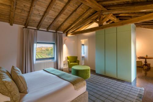 a bedroom with a large bed and a window at Dimora Cottanera in Castiglione di Sicilia