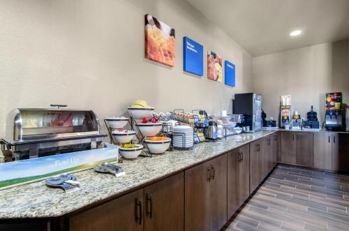 a buffet line with bowls of food on a counter at Comfort Inn St Robert-Fort Leonard Wood in Saint Robert