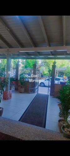 a sign that says good morning in a parking lot at Vila Mariss in Korçë