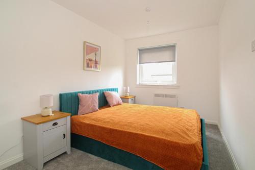 a small bedroom with a bed and a window at Greenside Getaway in Newarthill