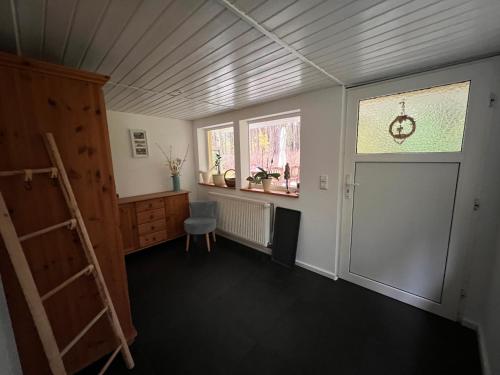 a room with a ladder and a window and a door at Ferienhaus im Wald in Borkwalde