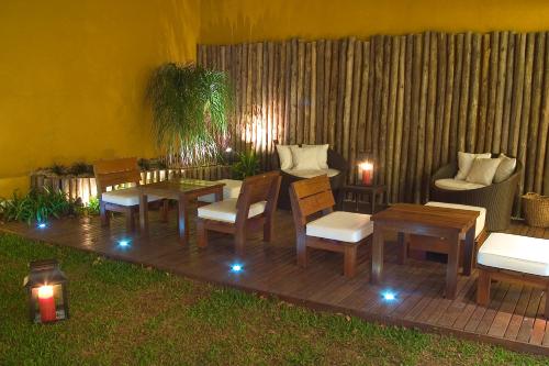 a wooden deck with chairs and tables and a couch at Mine Hotel in Buenos Aires