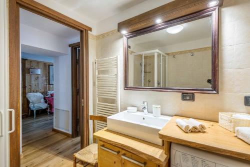 a bathroom with a sink and a mirror at LUVI - Courmayeur in Courmayeur