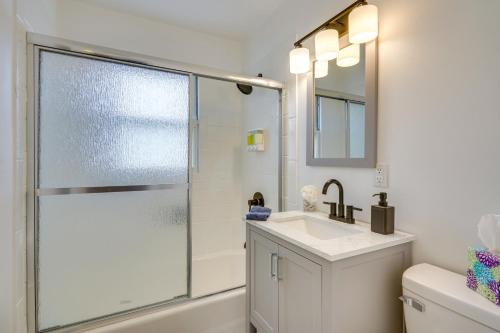 a bathroom with a shower and a sink and a mirror at Chic Pueblo Vacation Rental Home Near Fairgrounds! in Pueblo