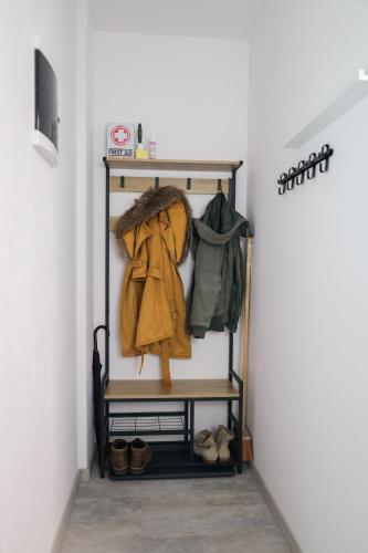 a hallway with a shelf with a coat and shoes at apartmán Argentum - Rezidence K Lanovce in Jáchymov