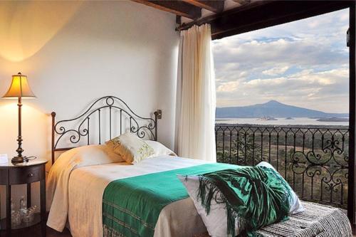 a bedroom with a bed and a view of the ocean at Porton del Cielo in Pátzcuaro